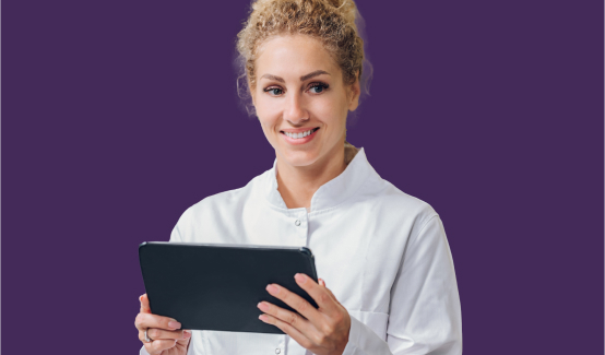 An image of a woman holding a tablet in her hand, standing in front of a blue background.