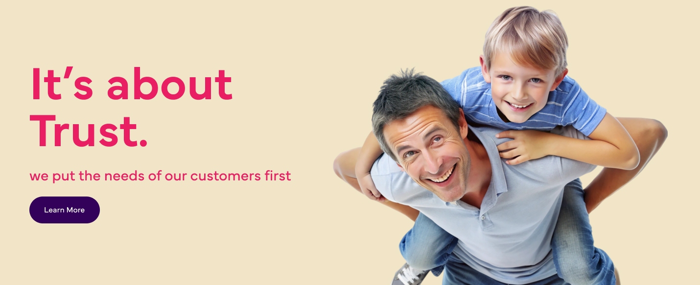 The image shows a man carrying a kid on his shoulders. The text reads, "It's about trust. We put the needs of our customers first." There is a "Learn More" button at the bottom left.