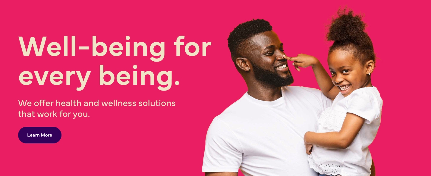 The image shows a man holding a smiling girl who playfully touches his nose. The text reads, "Well-being for every being. We offer health and wellness solutions that work for you." There was this "Learn More" button at the bottom left.